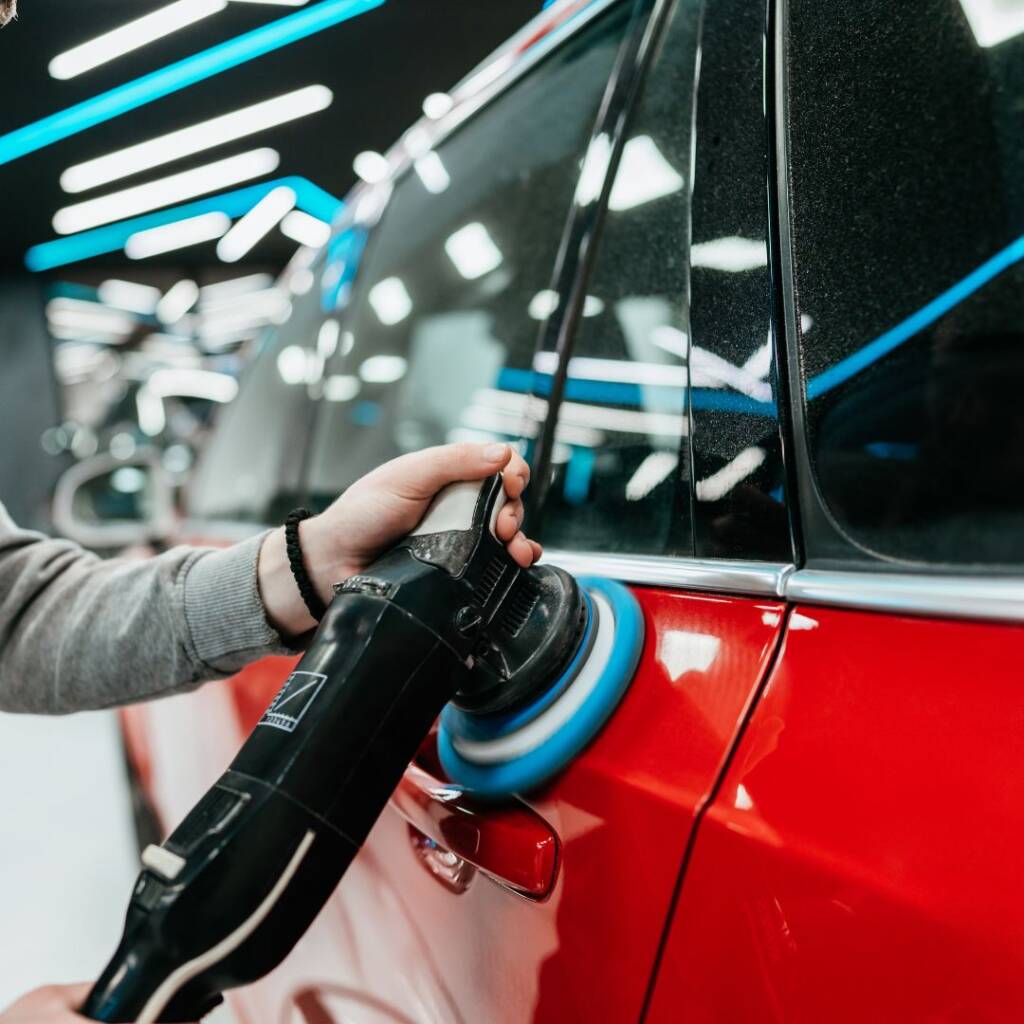 person applying coating to vehicle exterior